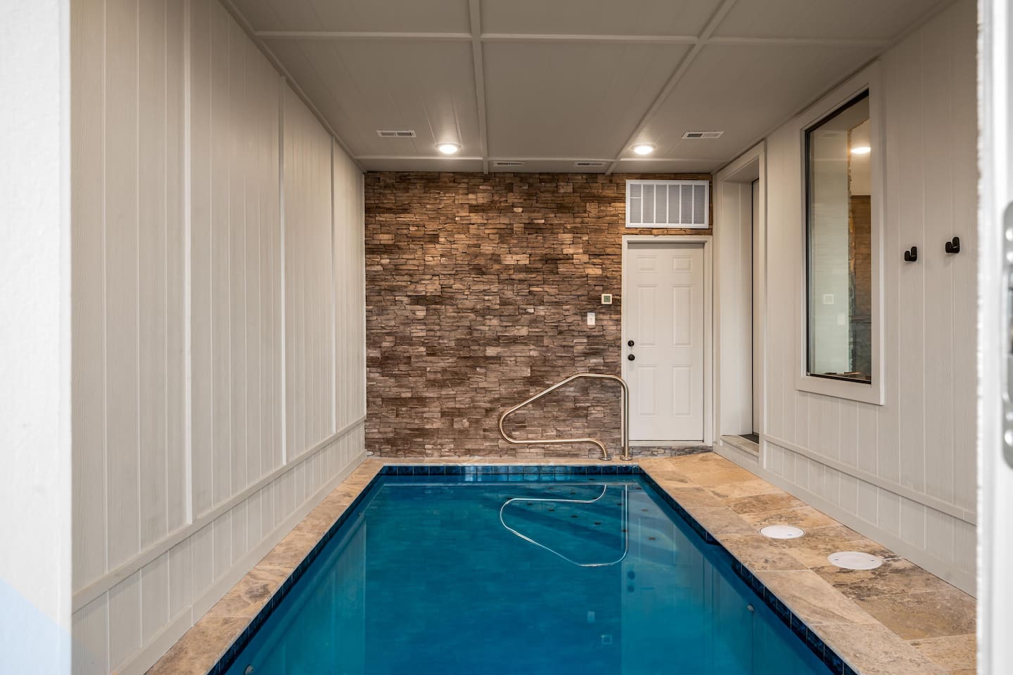 Luxury Gatlinburg Airbnb cabin featuring a private indoor pool, game room with pool table, mountain views, and upscale rustic design. 