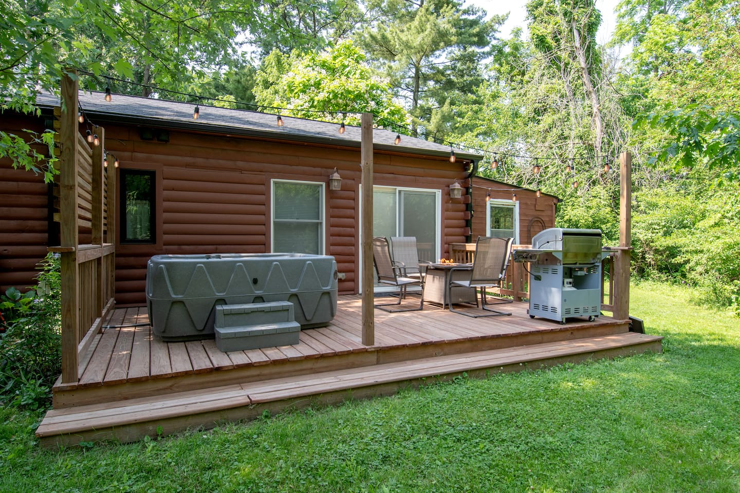 This is a great place to sit with a cup of coffee and listen to the birds and watch for deer and other wildlife. This deck is off the bedroom of the Guest Quarters. It has a 5 person hot tub, fire table and propane grill. 