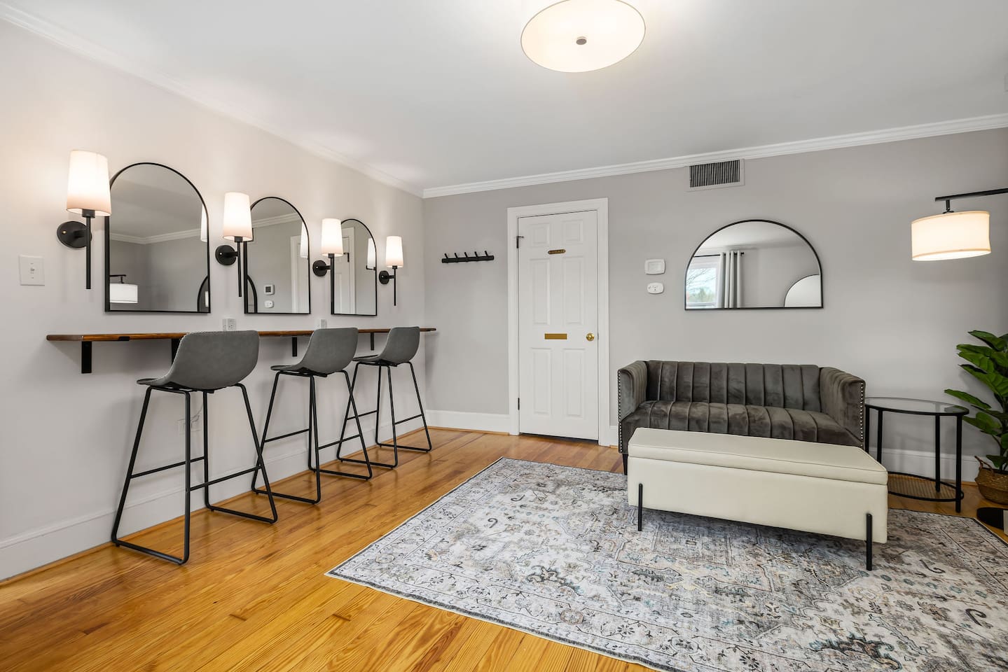 The getting ready room (also Bedroom #1)  includes a beauty bar for hair and makeup, small loveseat, full bathroom, oversized mirror, and a pull-down queen size Murphy bed.