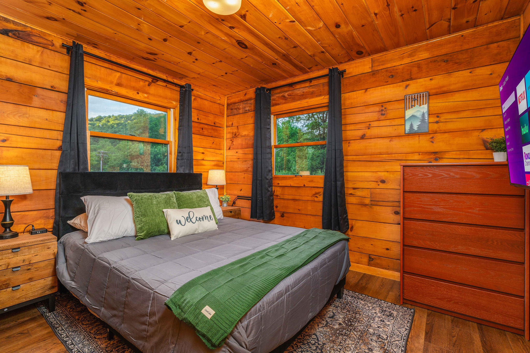 👑 Master bedroom — queen bed in calm, woodsy greens.
