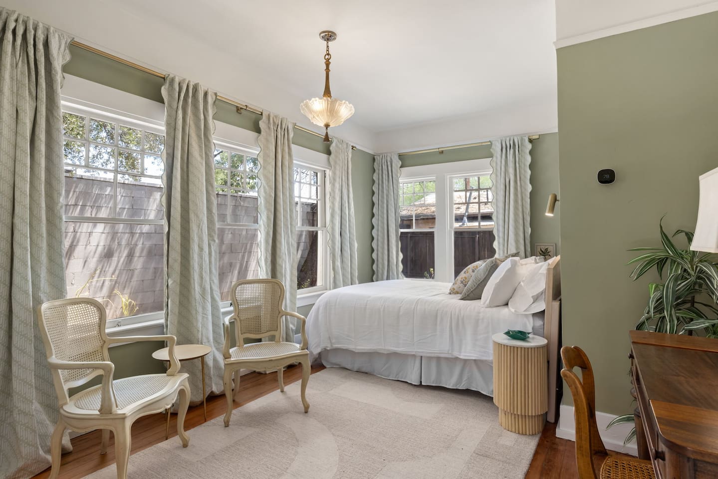 back bedroom with 5 windows and blackout curtains