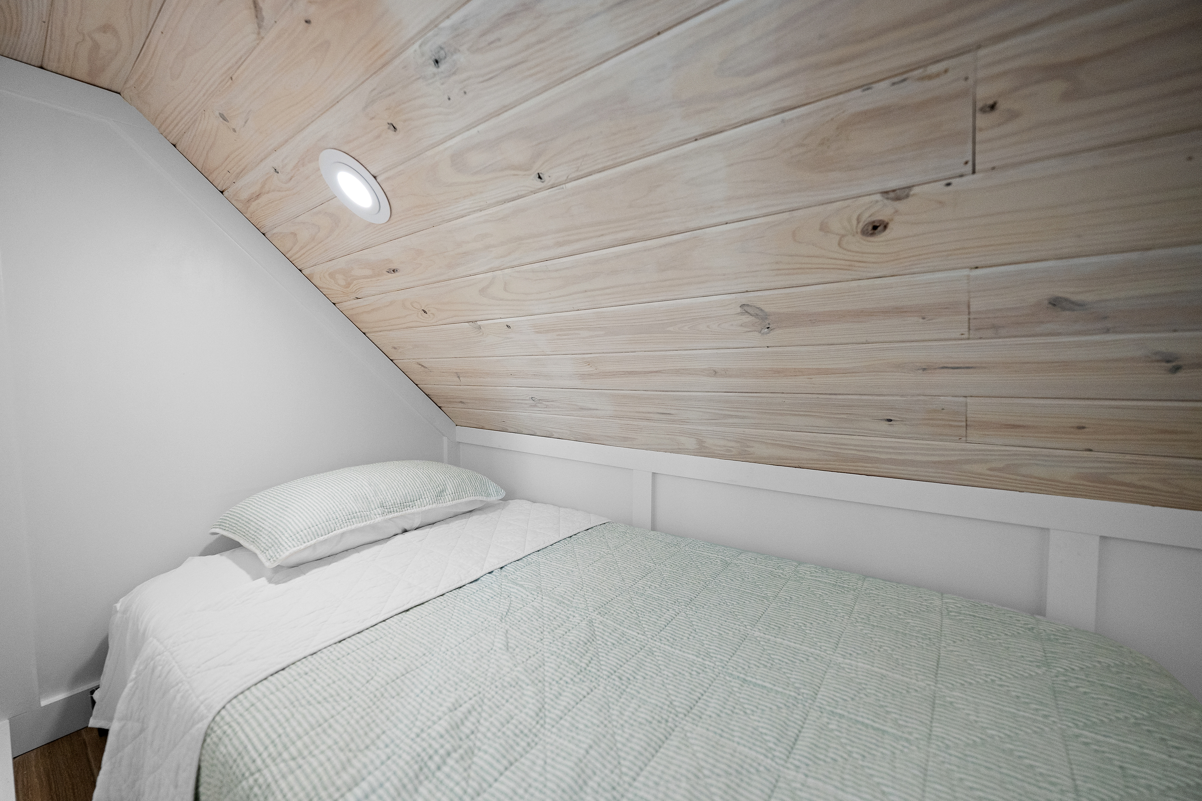 Twin floor-mattress sleeping nook tucked into the upstairs queen bedroom.