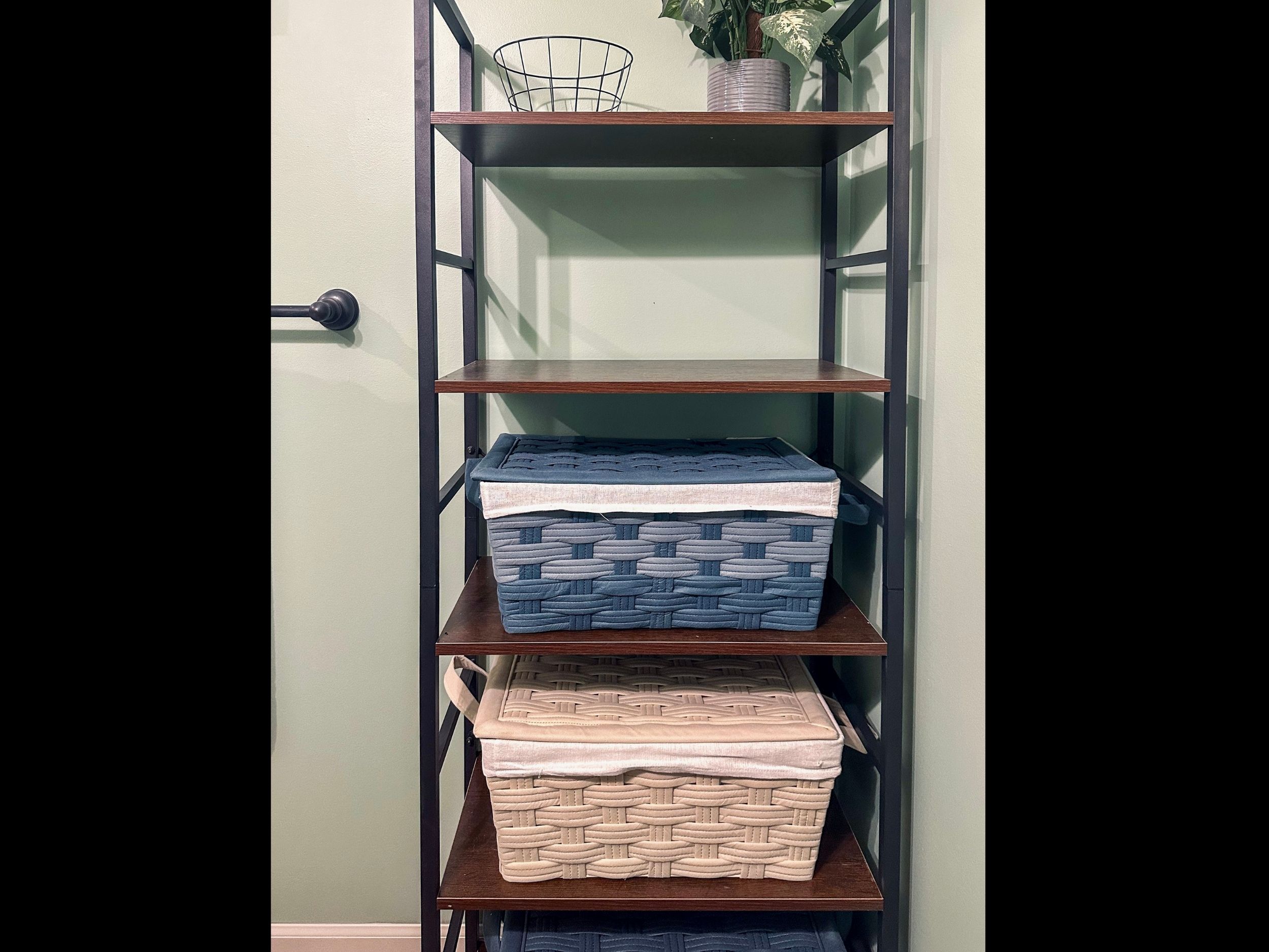 Half bath shelving off the living room, neatly arranged with accessible storage for everyday essentials.