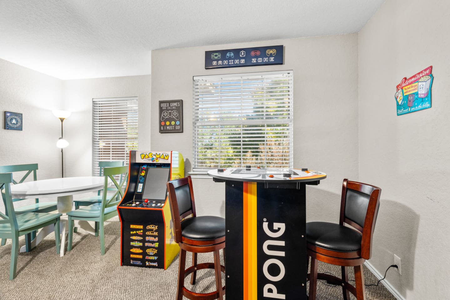 Spacious game room with Pac-Man, board games, and a theater-focused setup that’s perfect for relaxing after exploring San Antonio.