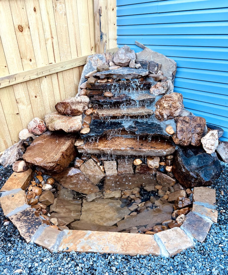 Outdoor Oasis: Enjoy tranquil moments by the charming waterfall feature in the private yard!