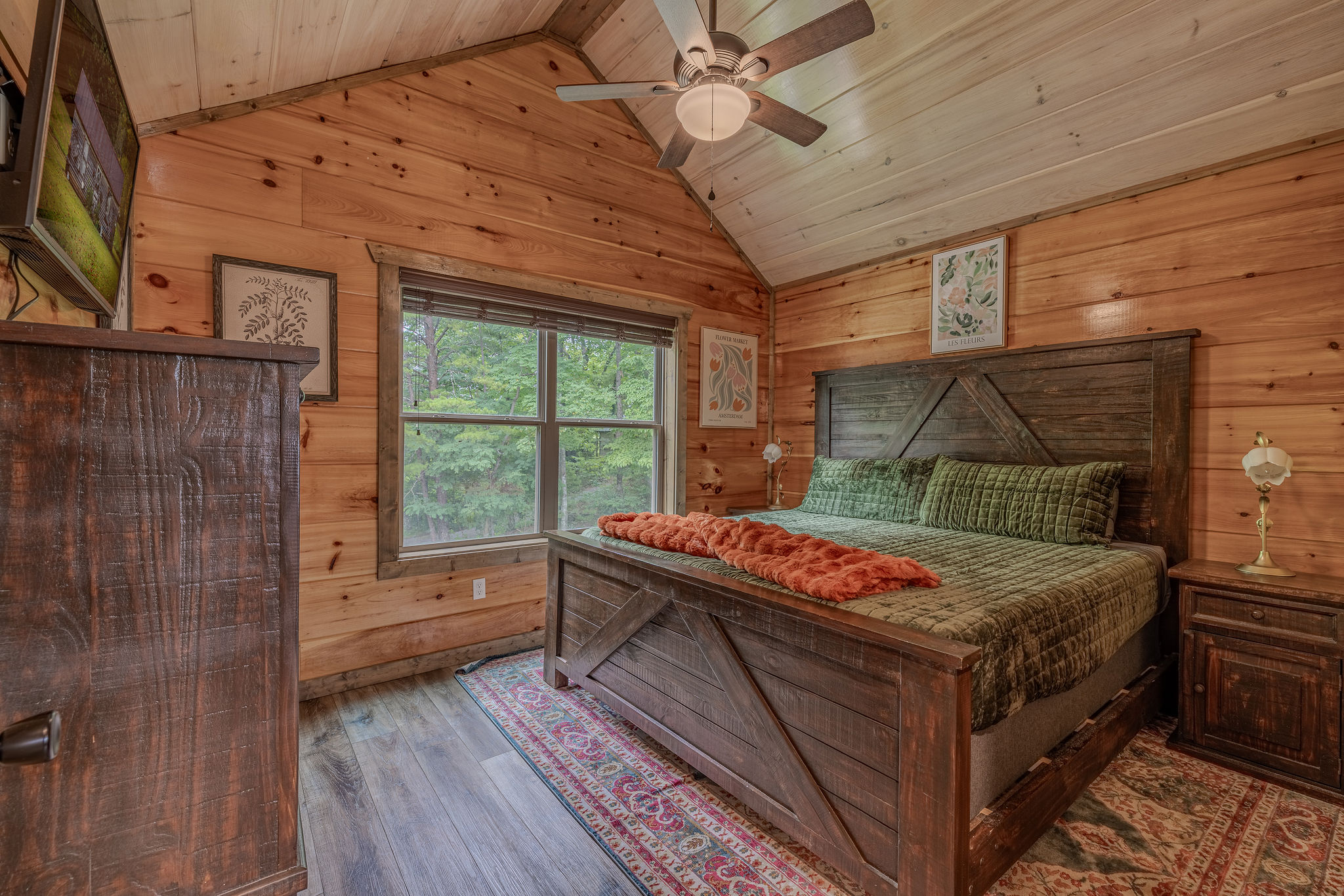 The Botanist Suite is a king bedroom with earthy style, warm wood, and restful mountain character.