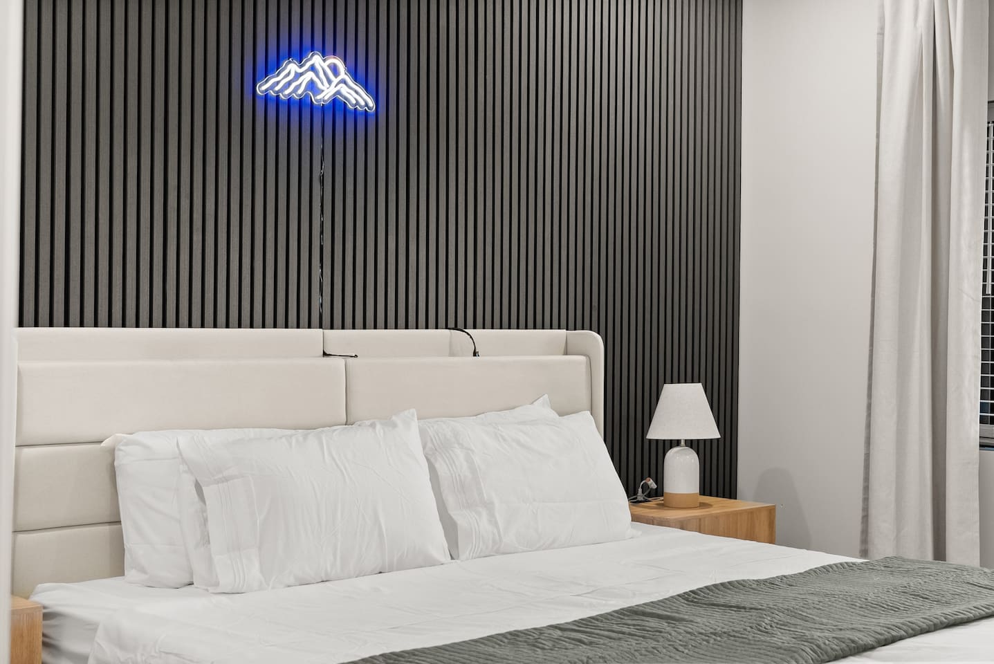 Two twin beds placed close together, easily separated if needed, with convenient built-in phone chargers—practical and comfortable for any guest.
