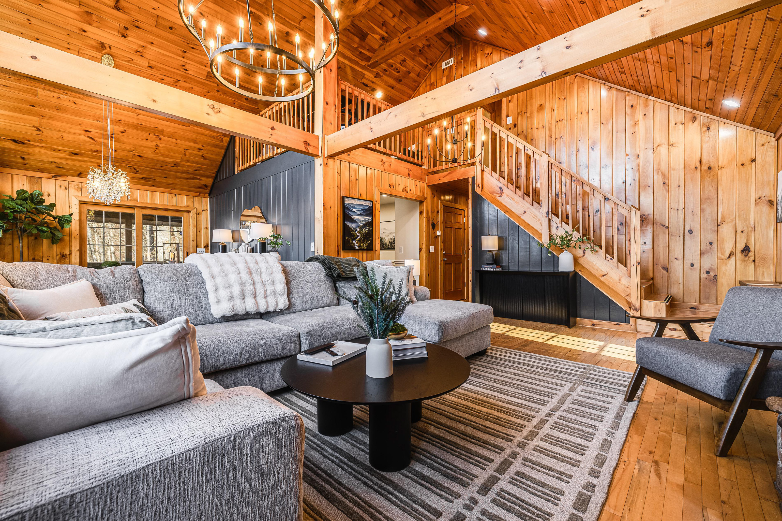 Unwind in our tastefully curated living room, featuring a spacious and comfortable sofa perfect for relaxing after a day of mountain adventures.