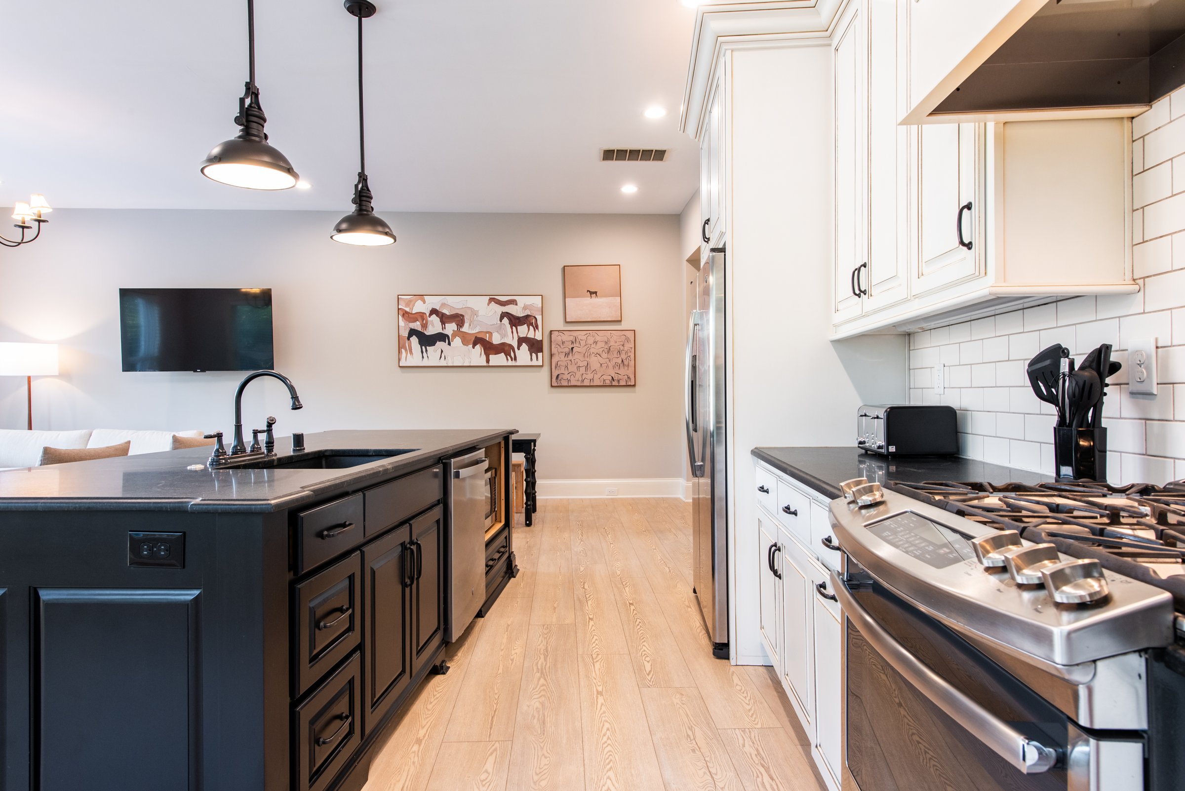Stainless refrigerator and abundant cabinet storage in the fully stocked kitchen.