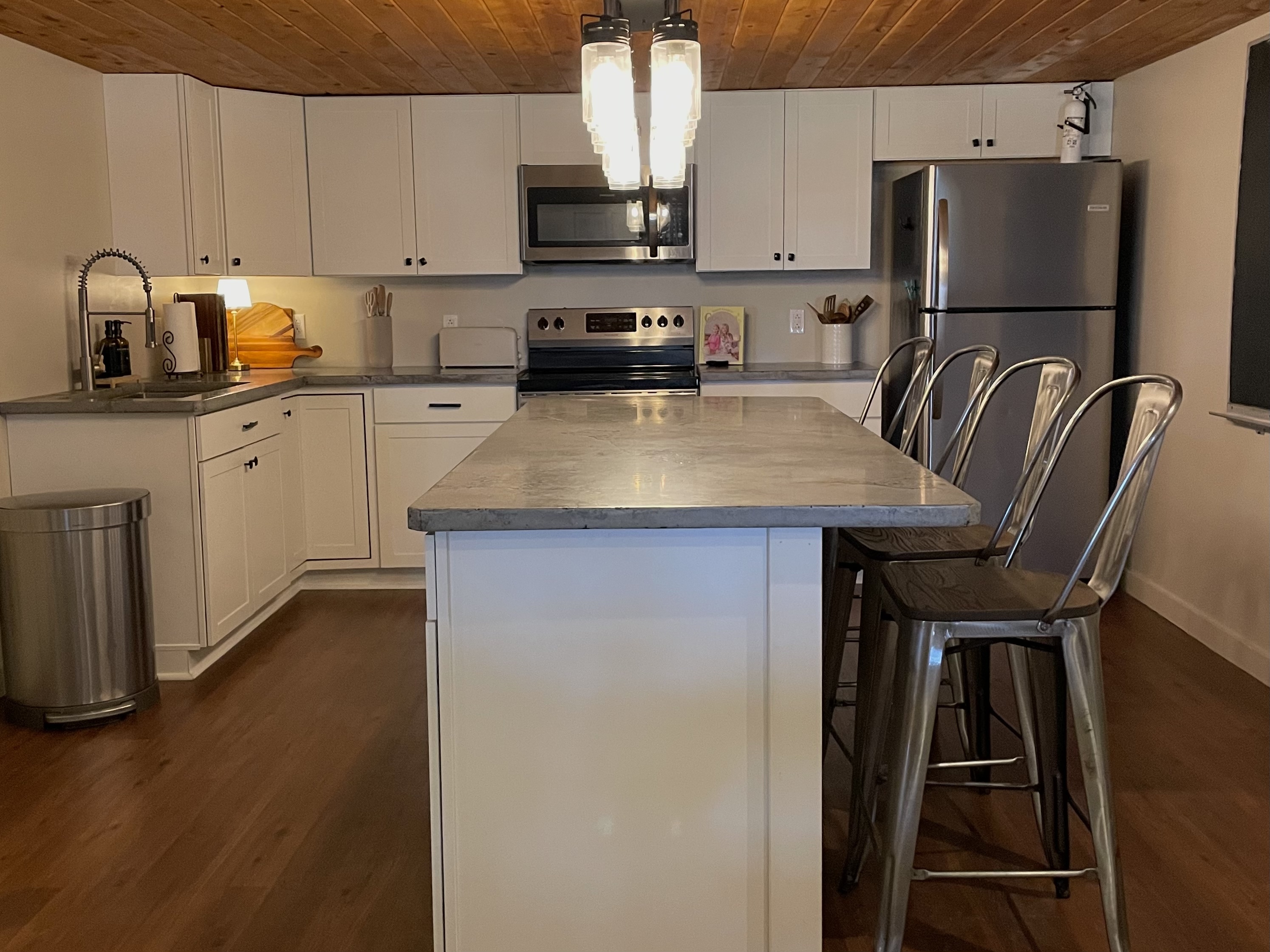 Kitchen includes stove, microwave, refrigerator, and all cooking essentials