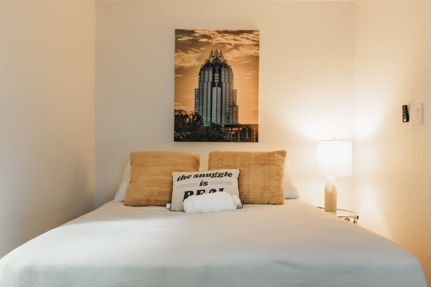 Bedroom with comfy queen bed and original texas art