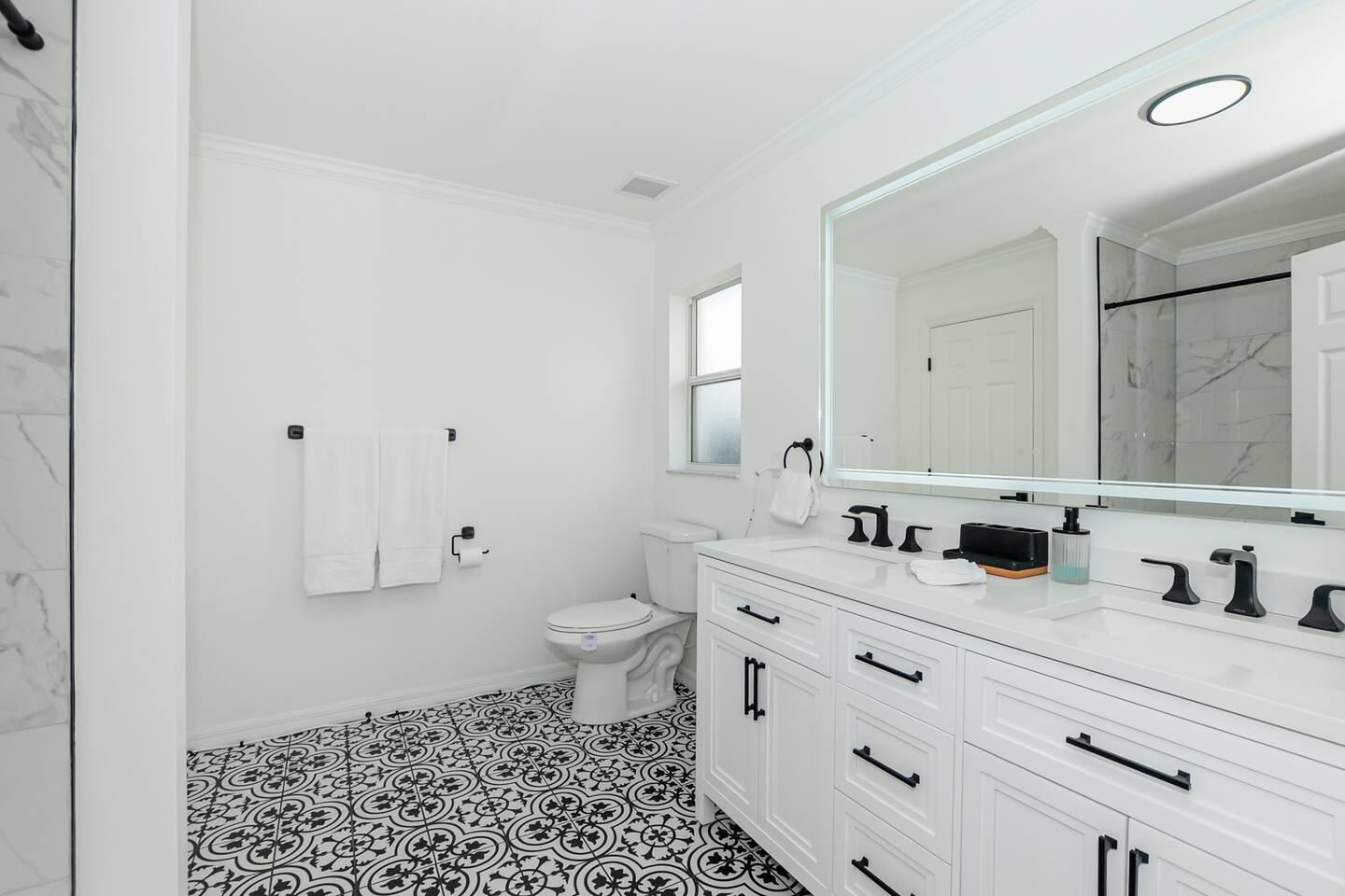 Full bathroom featuring a sleek toilet and modern sink, offering both style and functionality.