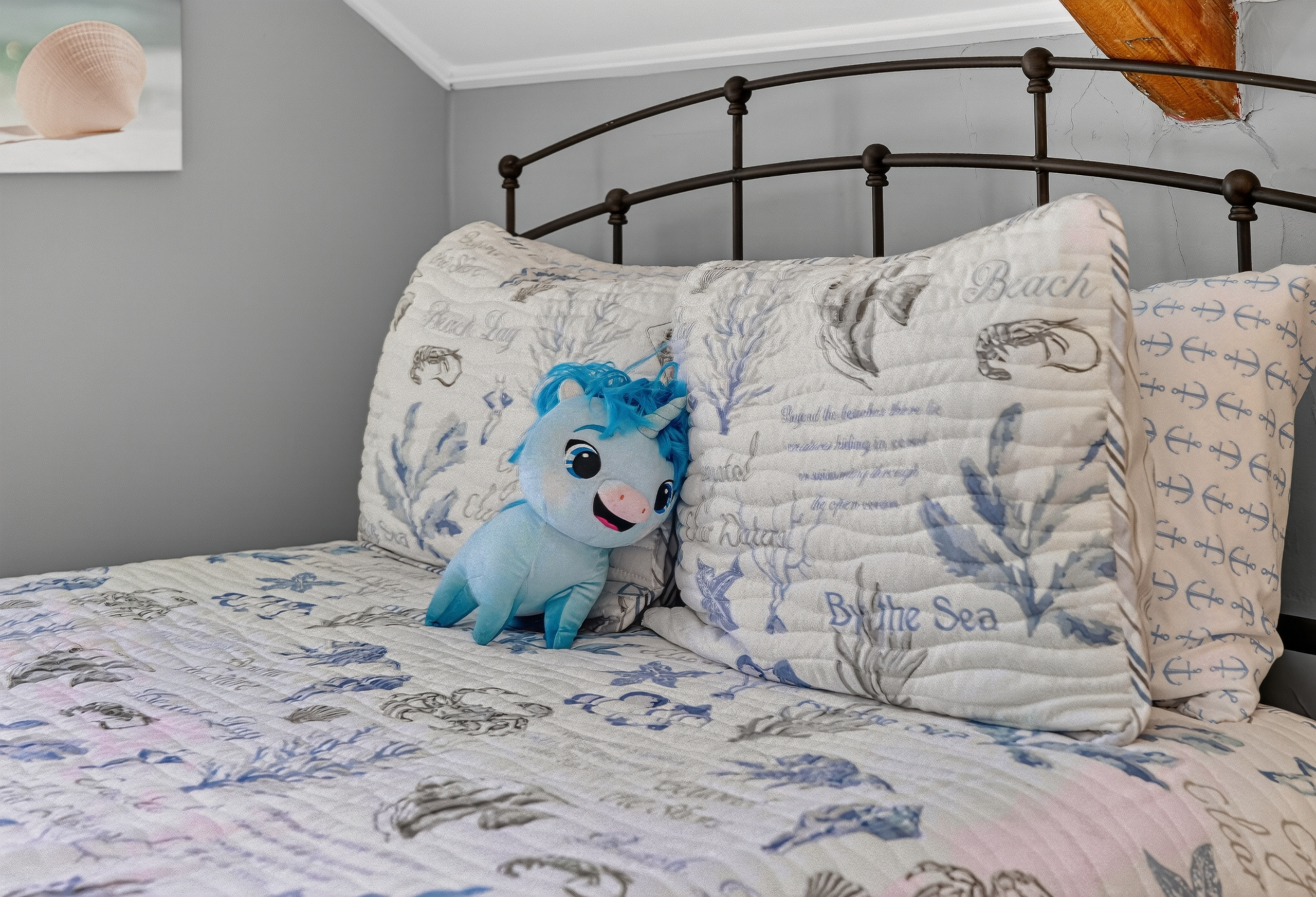 Plush bed with premium linens and thoughtful coastal-inspired accents for a restful night's sleep.