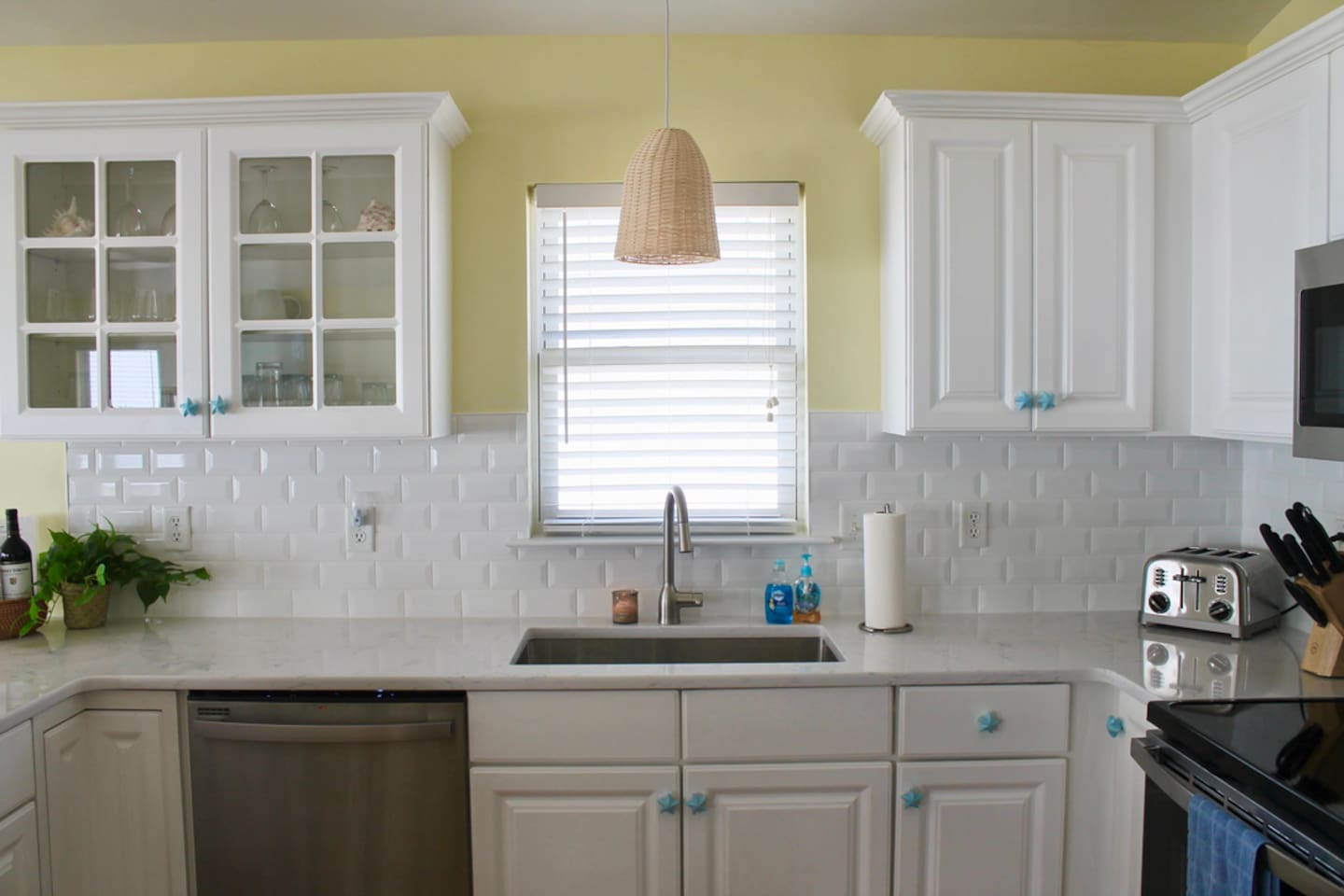 Stainless steel faucet and sink. Subway tile backsplash. 