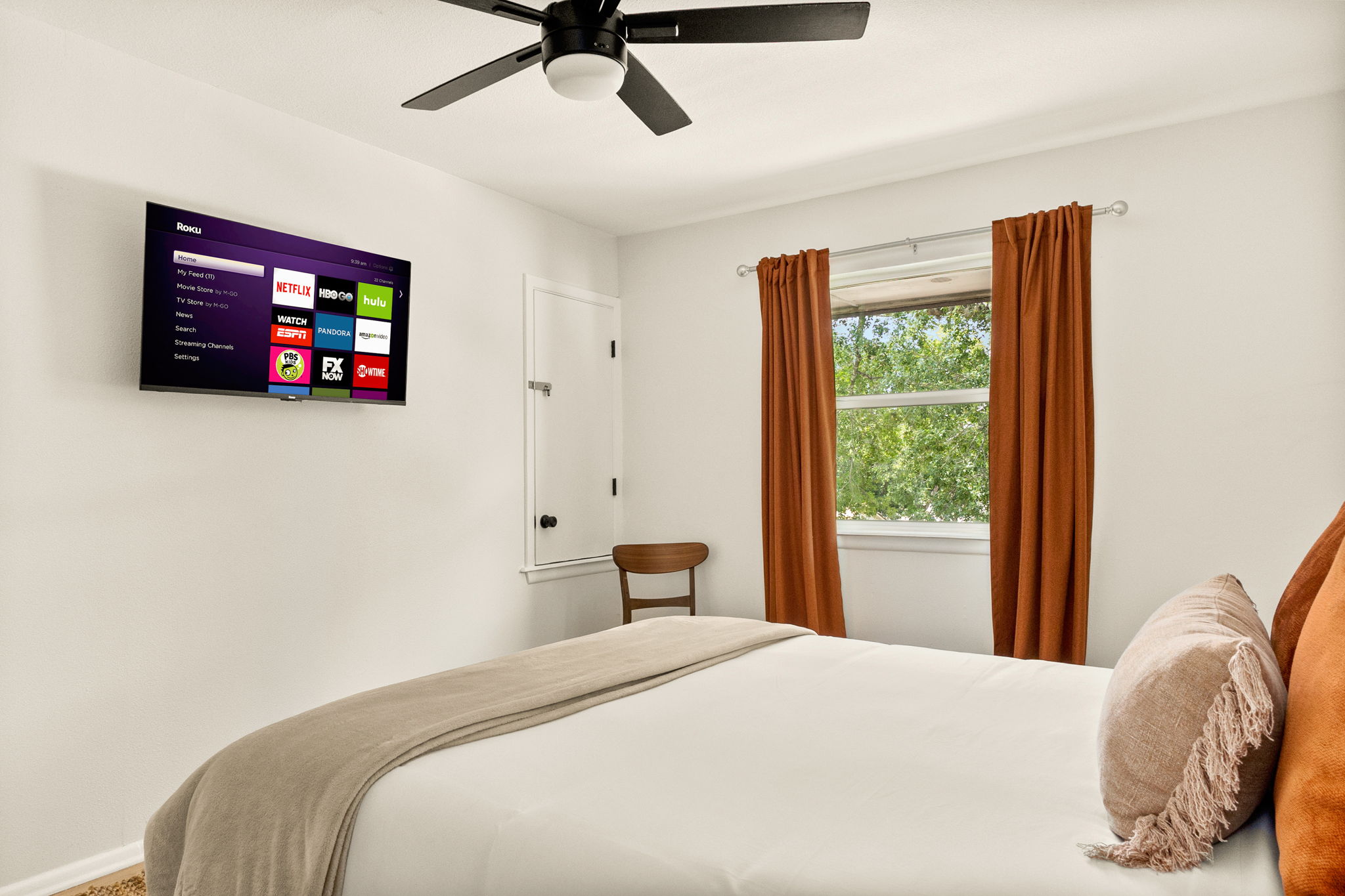Comfort meets entertainment with a Smart TV conveniently placed for easy viewing from bed.