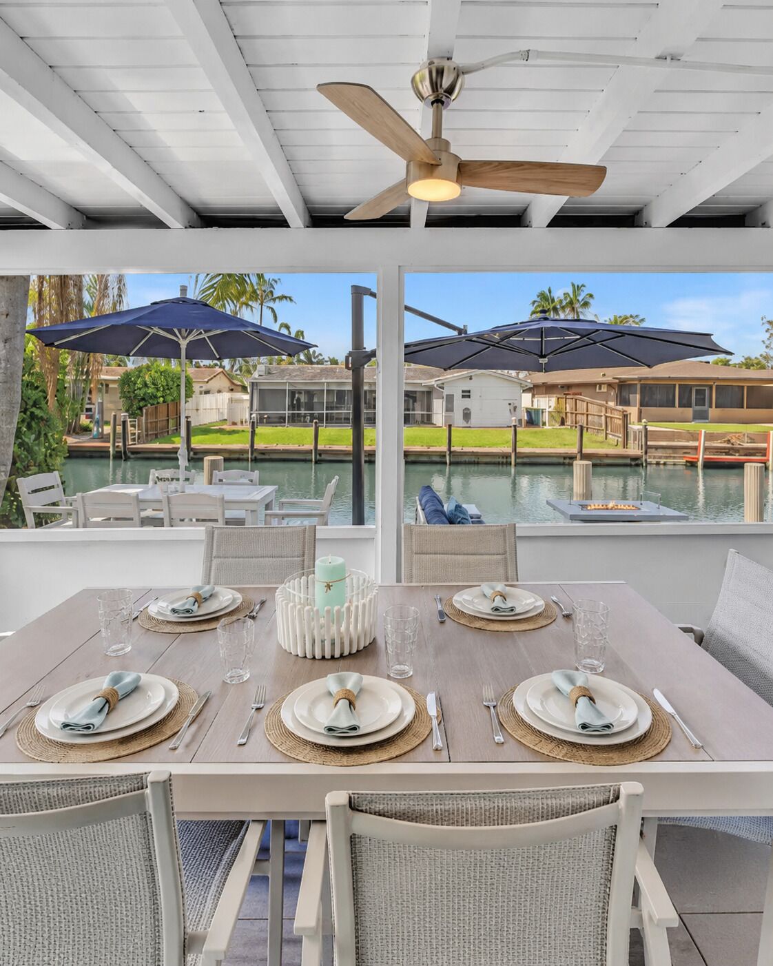 Relax on the screened waterfront patio with comfortable seating, dining space and a 65” TV.
