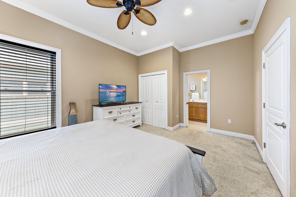 Bedroom with plush bedding and TV