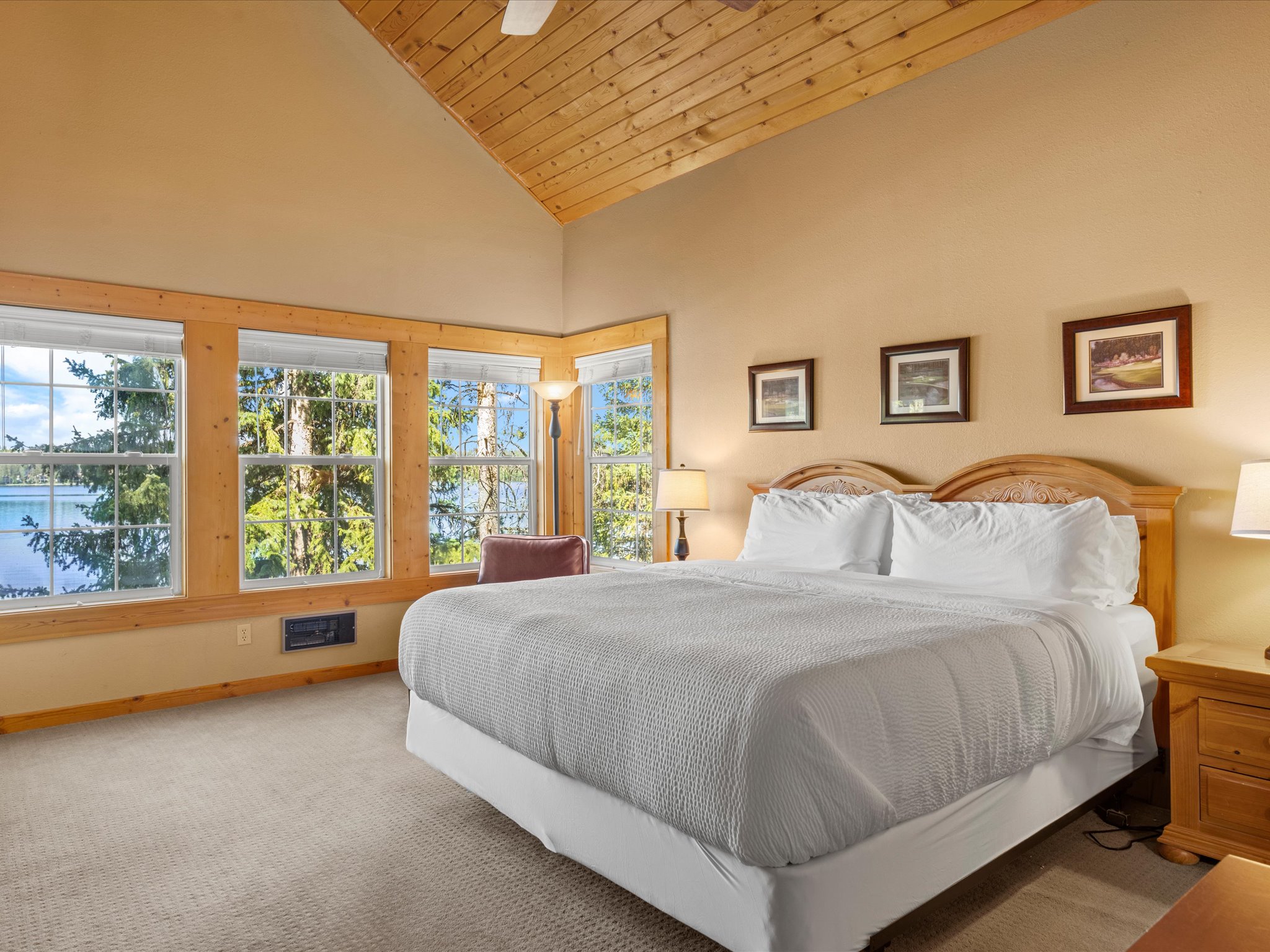 King bedroom with private lake-view balcony — Frederick Lakeside Lodge