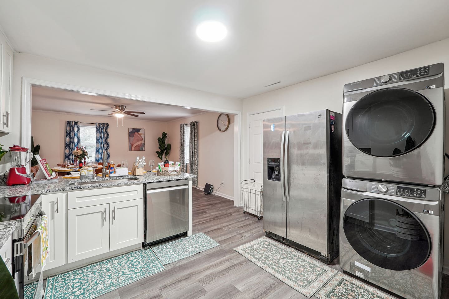 A convenient laundry area featuring a washer, dryer, and laundry essentials like detergent and fabric softener — perfect for guests who need to do laundry during their stay.
