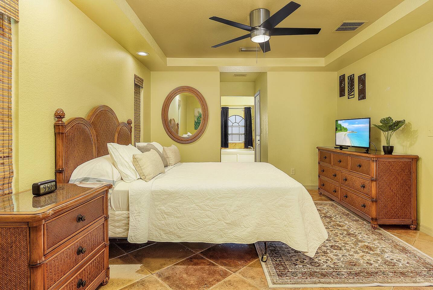 Indulge in a plush queen-size bed and tropical decor in the primary suite!