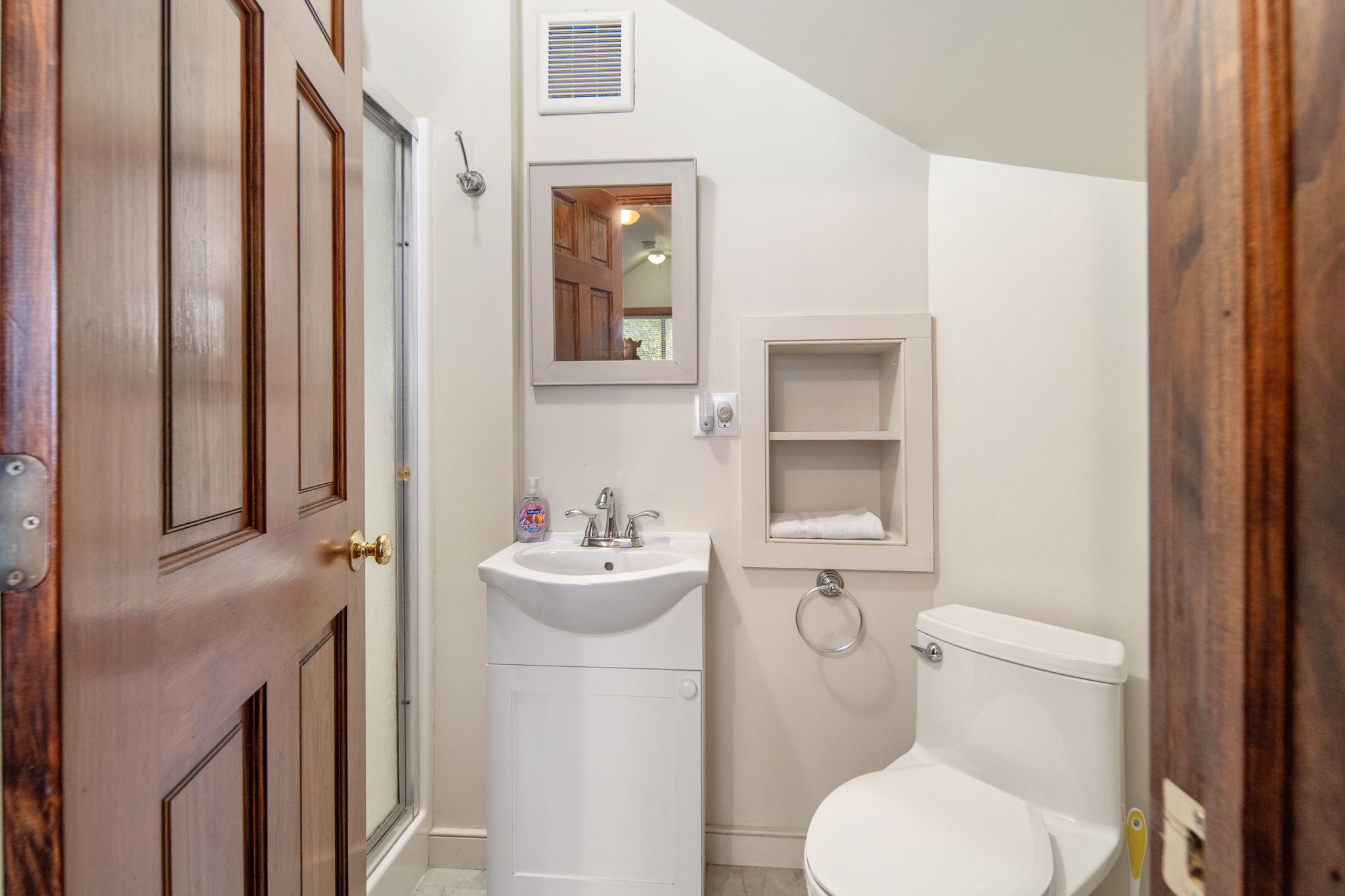 A conveniently located upstairs bathroom with a walk-in shower.