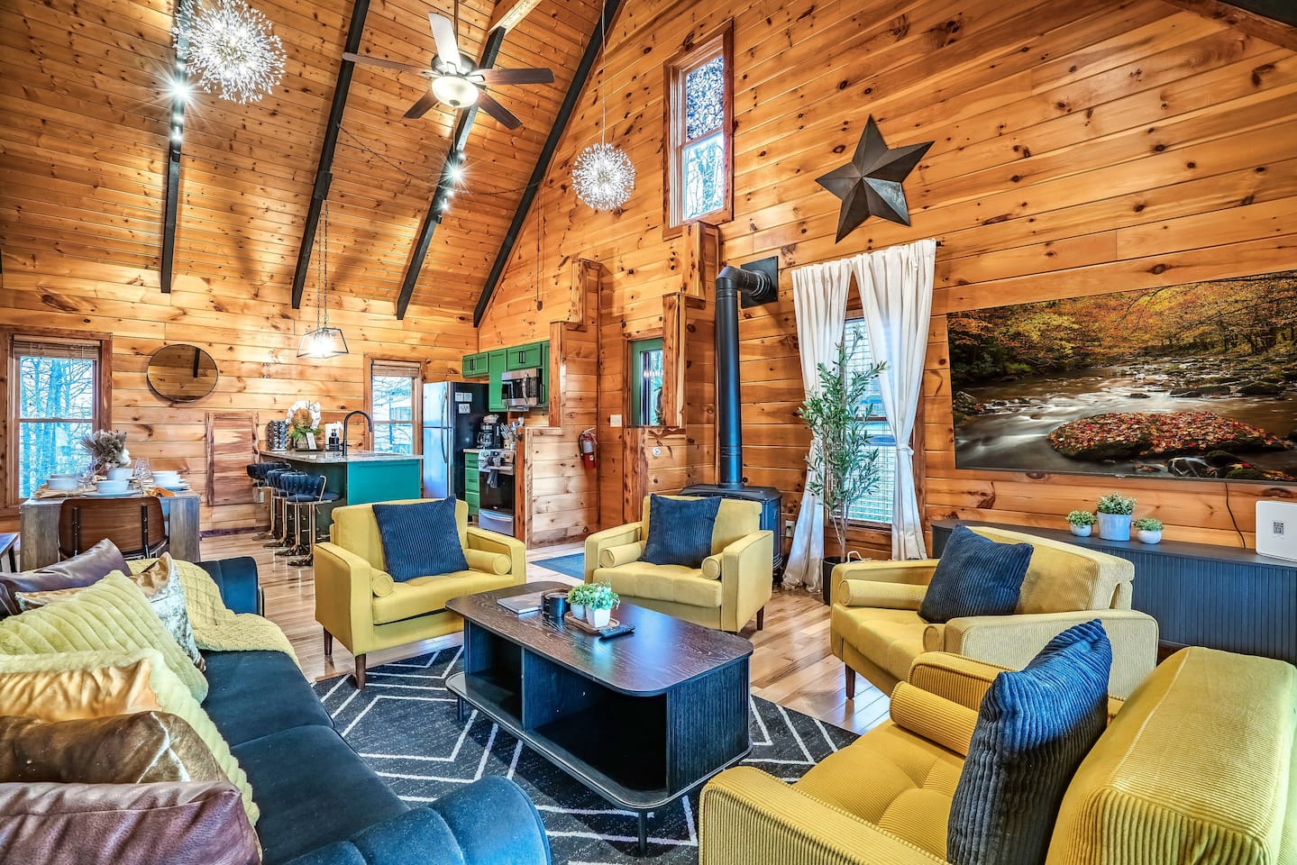 Another angle showing the main living room with the kitchen and dining area in the background.