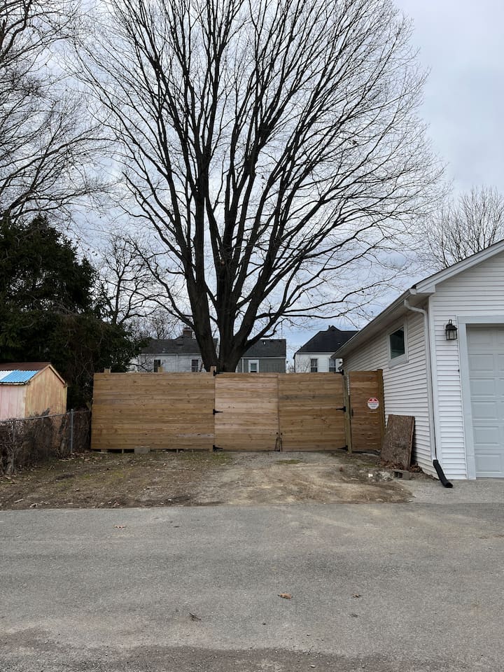 Parking area in the back for guests. Use the far right door on the right to walk into back yard to house. 