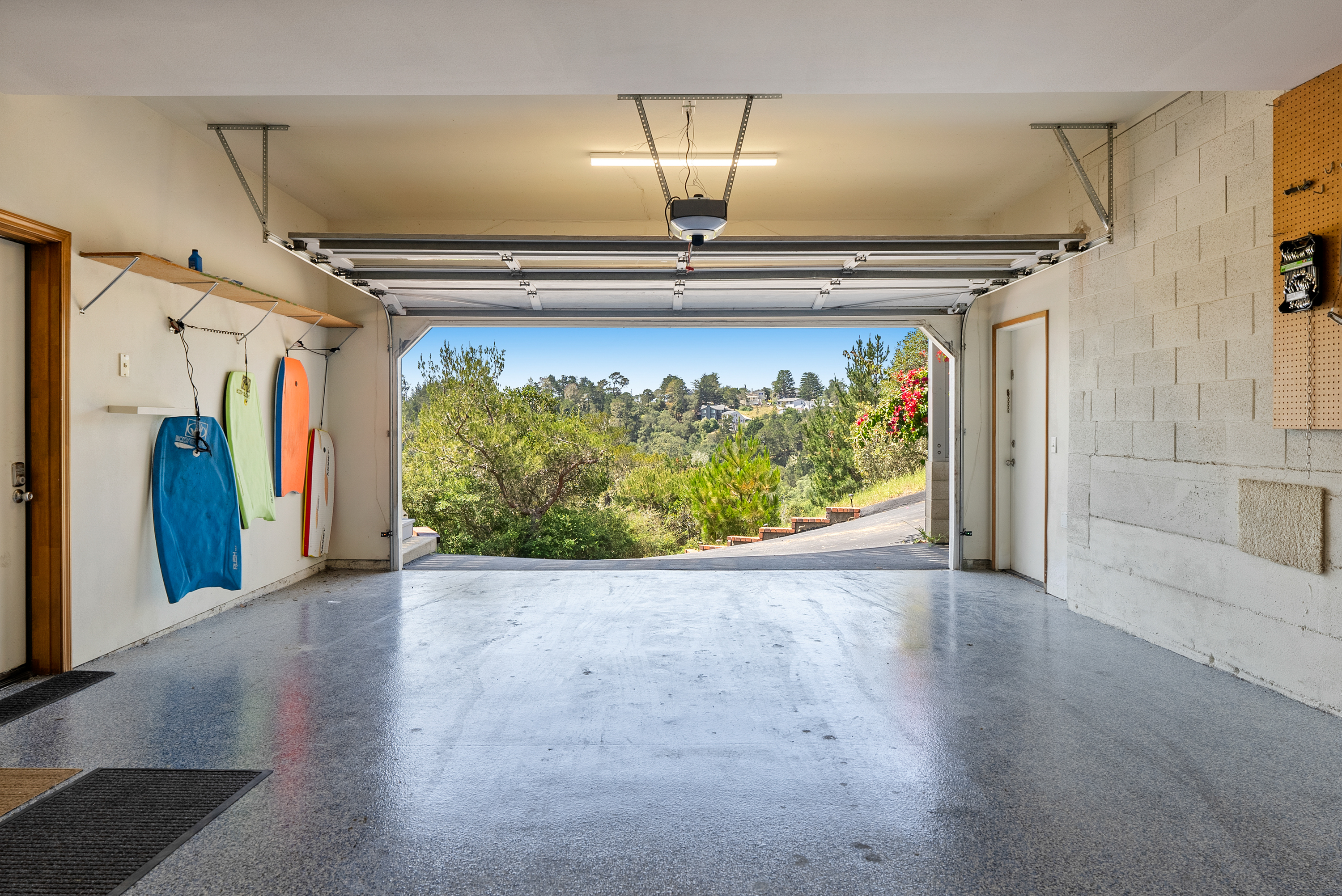 Spacious garage with an EV charger for modern convenience.