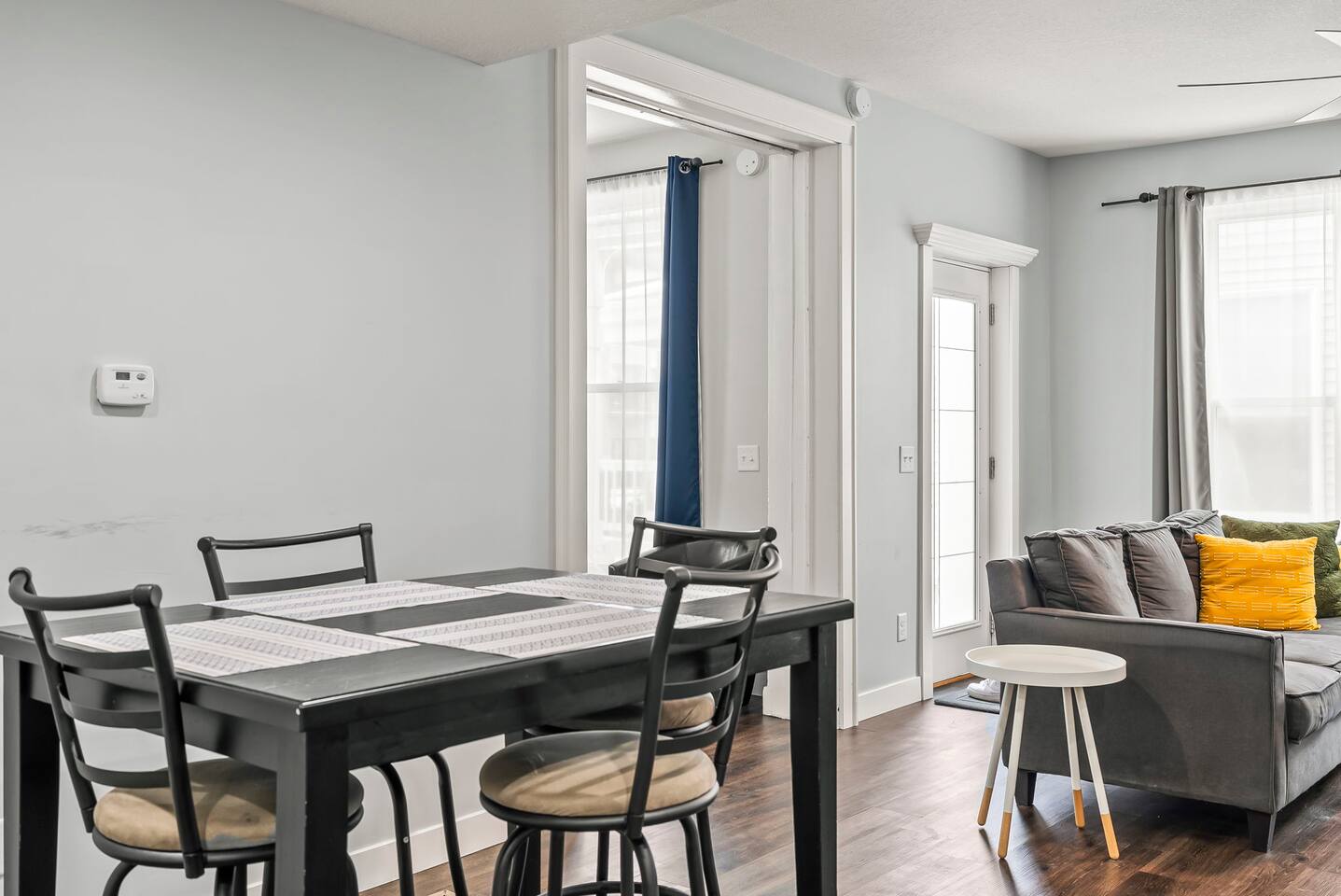 Dining table set near the living area, creating an easy flow between cooking, dining, and lounging.