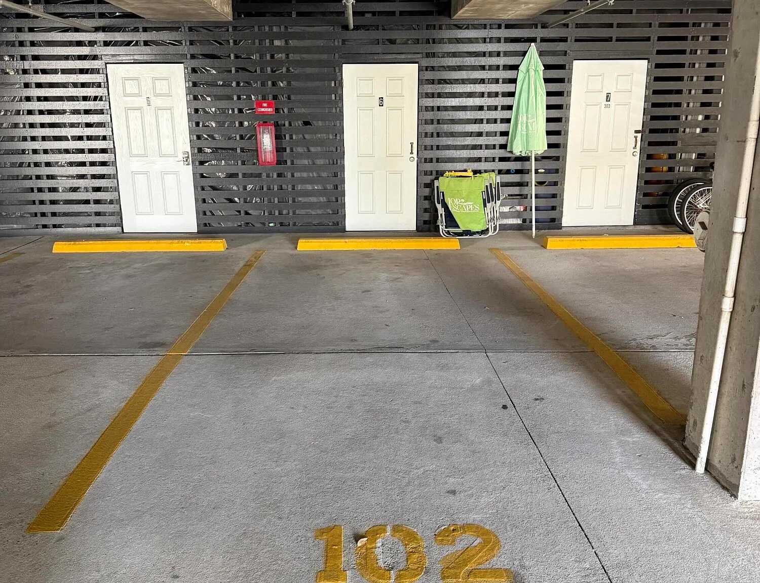 1 of 2 parking spaces with storage locker.  Guests staying 3 nights or more receive a beach gear credit (items pictured) | 1006 Ocean Blvd, Isle of Palms, SC | 102 Dunescape | IOP Escapes