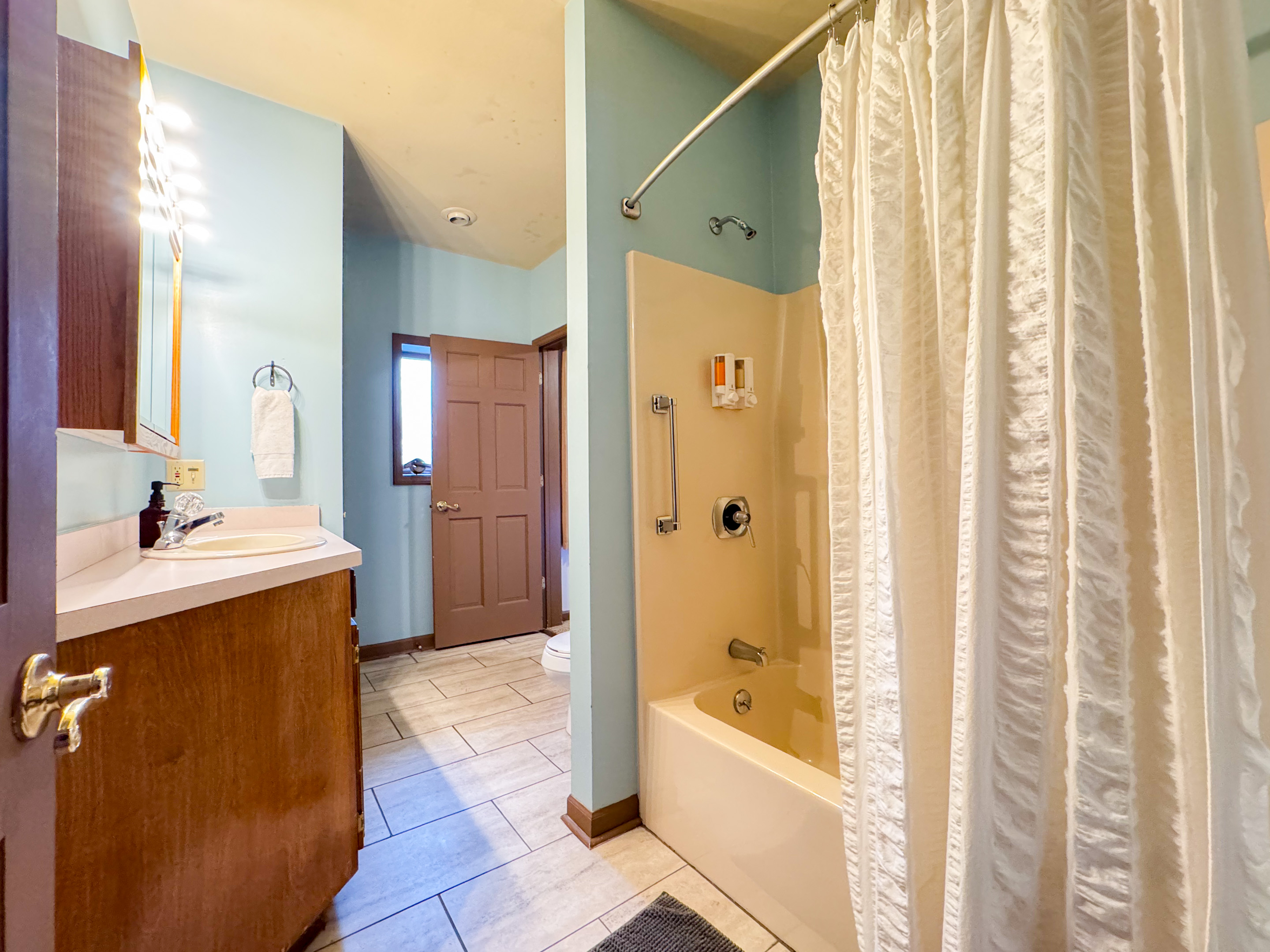 Full bathroom with tub/shower combination.