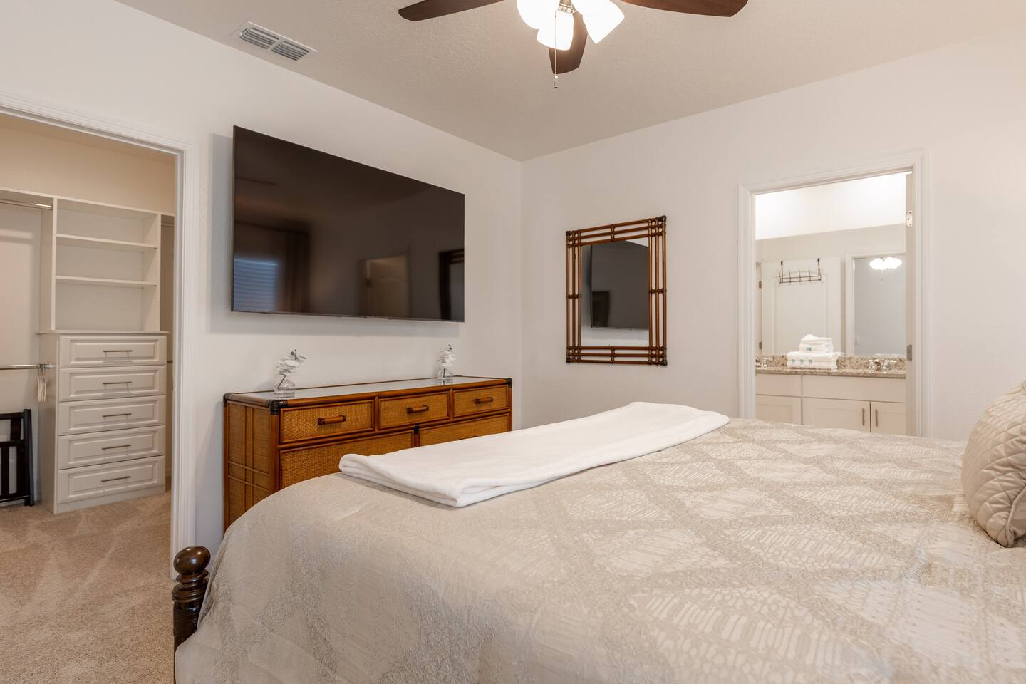Upstairs Tommy Bahama Themed Room with King  Bed and private bathroom,  shower and large closet. Includes a 70  inch TV.  Luggage rack & laundry basket in closet.
