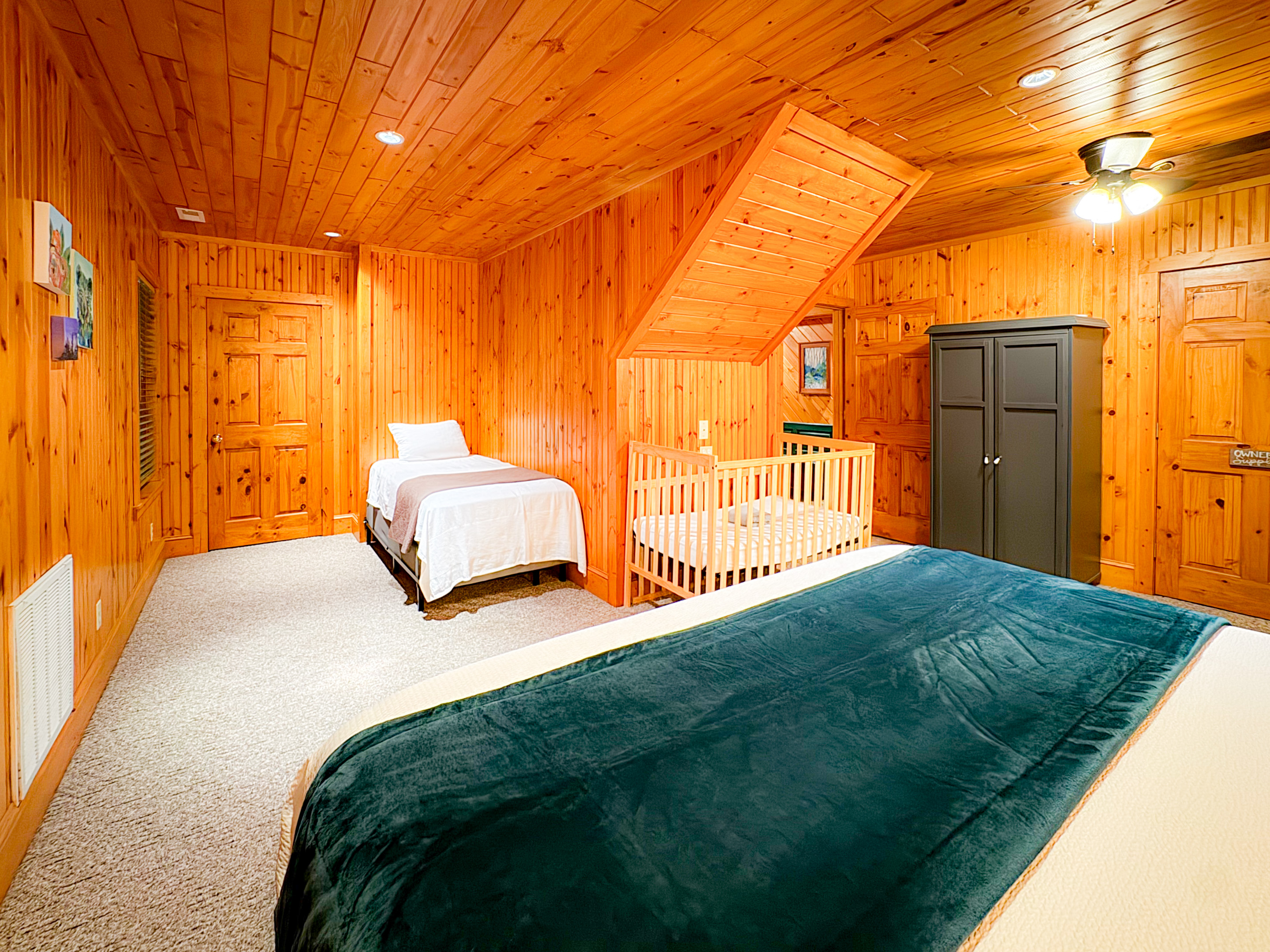 large bedroom one the lower level with a king bed, crib/pack-n-play, twin bed