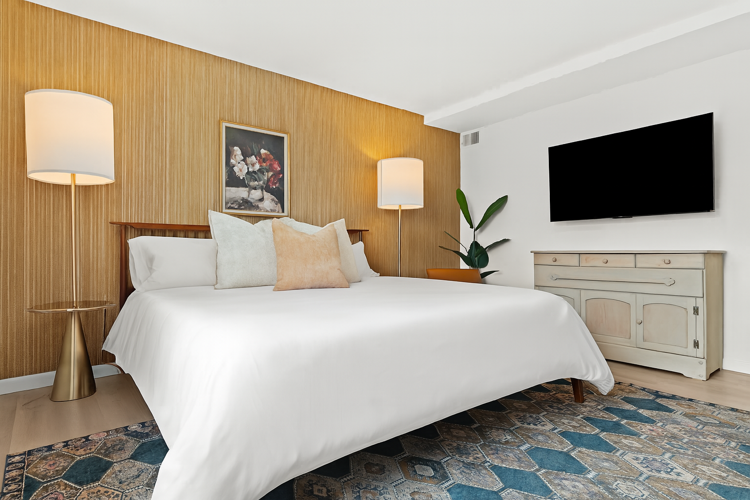 Unwind in this second king bedroom, complete with mounted TV, vintage dresser, and ample closet space.