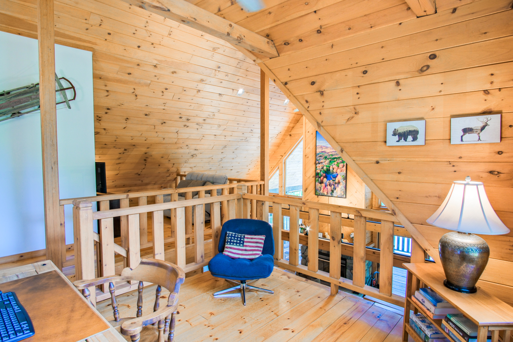 The mezzanine also offers a fully-functional work space. Monitor, keyboard, mouse, and fast wifi. Bonus: your zoom background will be the massive cathedral ceiling of the family room