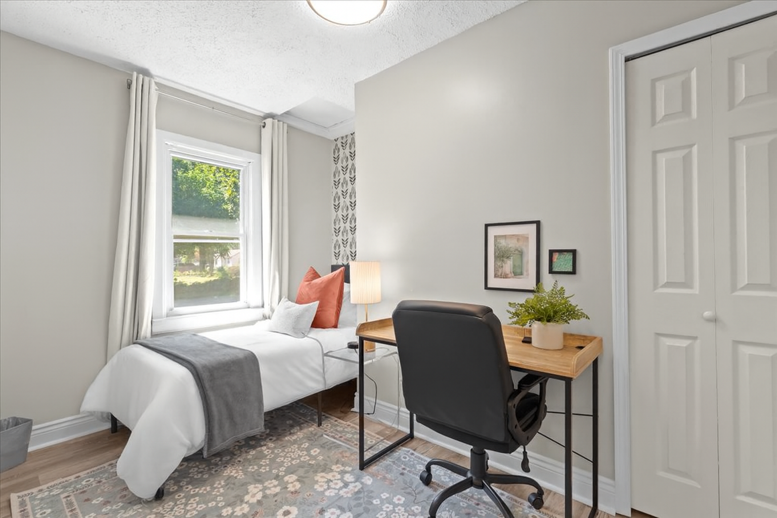 Bedroom with twin bed and workspace, ideal for kids or remote work
