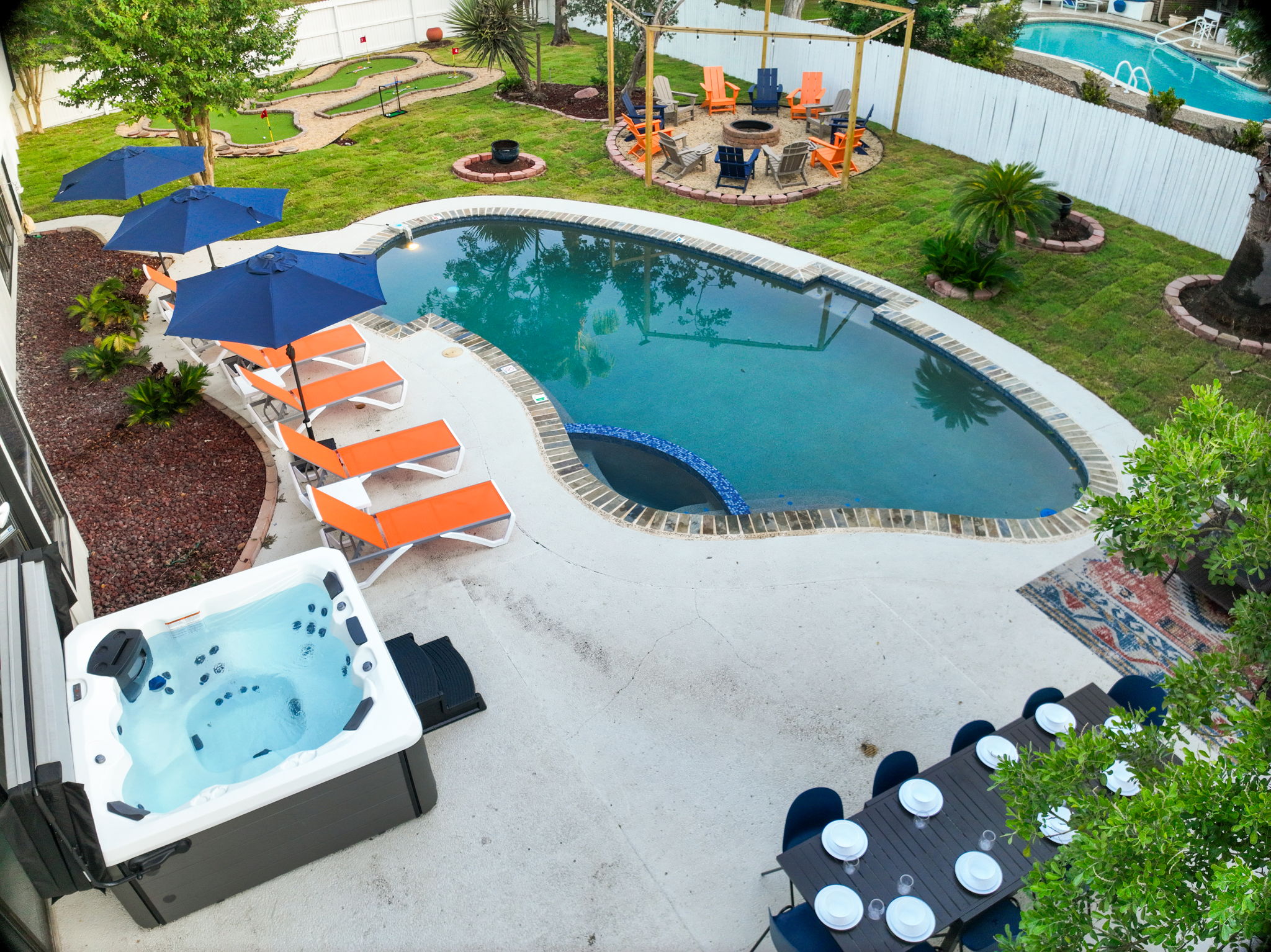 Unwind in the bubbling hot tub while enjoying views of the pool, mini golf, and firepit. The expansive patio offers outdoor dining for 10 and poolside loungers, the perfect backdrop for your San Antonio escape.