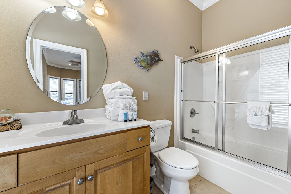 Bathroom with vanity, tub/shower combo, and toilet