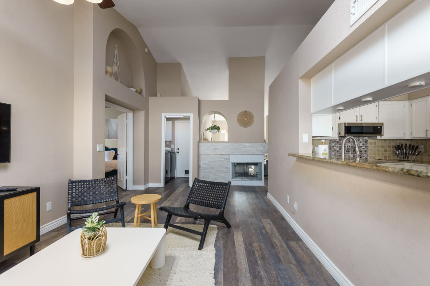 Living area with fireplace, TV, kitchen pass-through, and comfortable seating for relaxed indoor downtime.