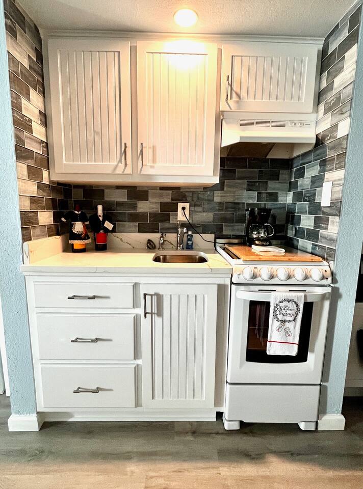 Recently updated kitchenette area provides a full stove and oven, microwave, full fridge/freezer and shelving for coffee and other useful appliances --perfect for enjoying some meals and mixing up cocktails!