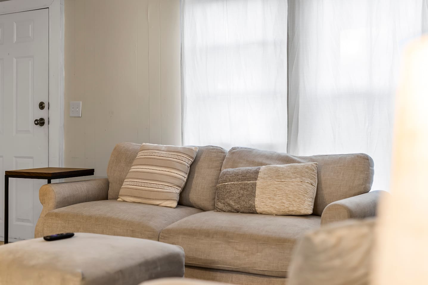 Stylish loveseat with accent pillows adding comfort and charm to the living room setup.