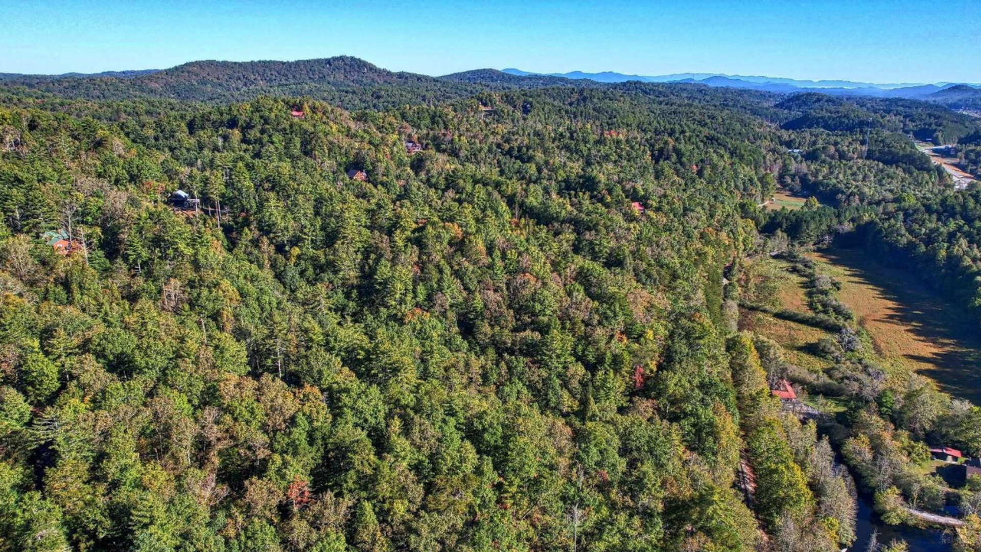 Aerial view of the neighborhood with cabin to the right.