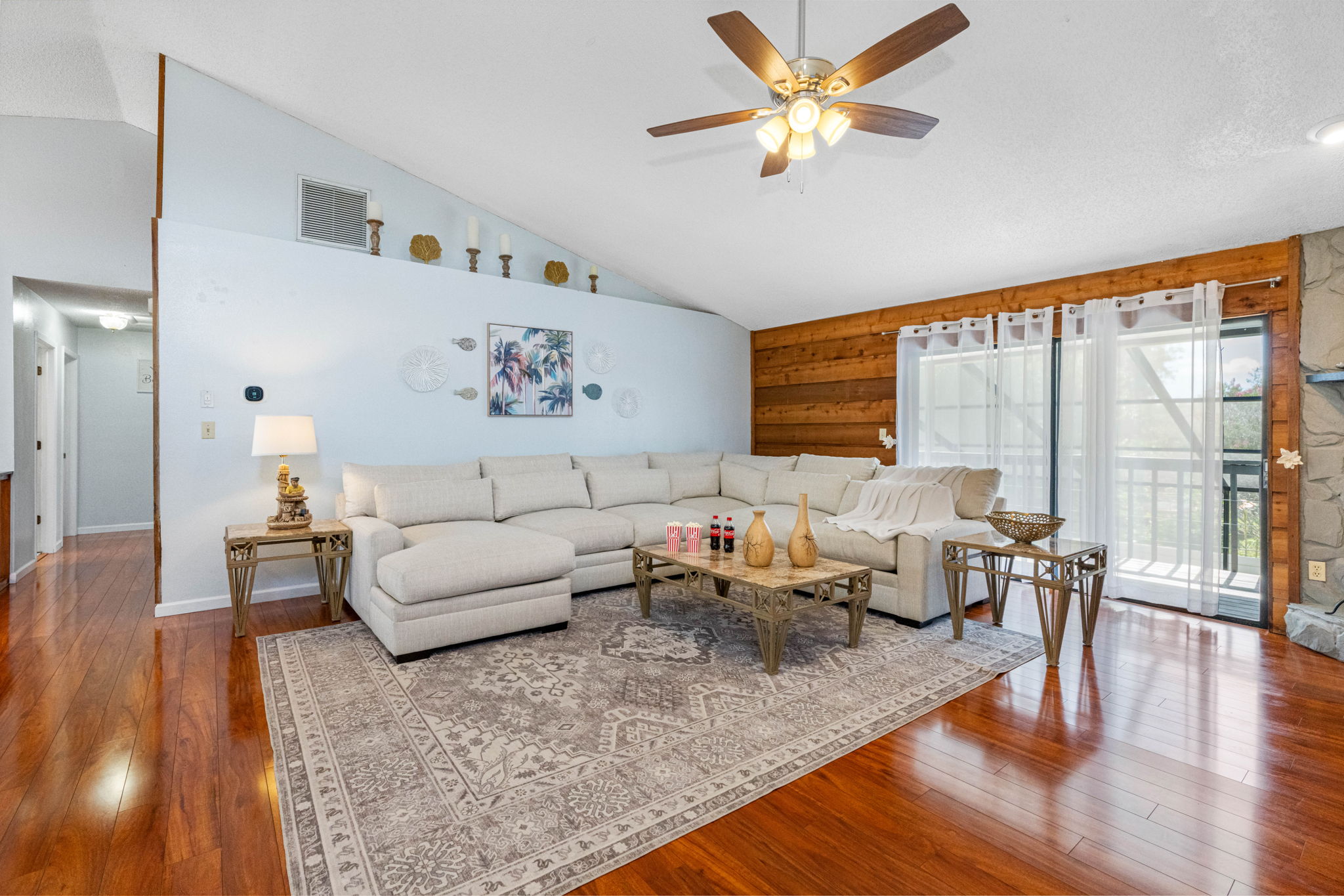 This spacious living room combines coastal decor with warm wood finishes and soft textures—making it an ideal spot to gather, recharge, and feel at home.