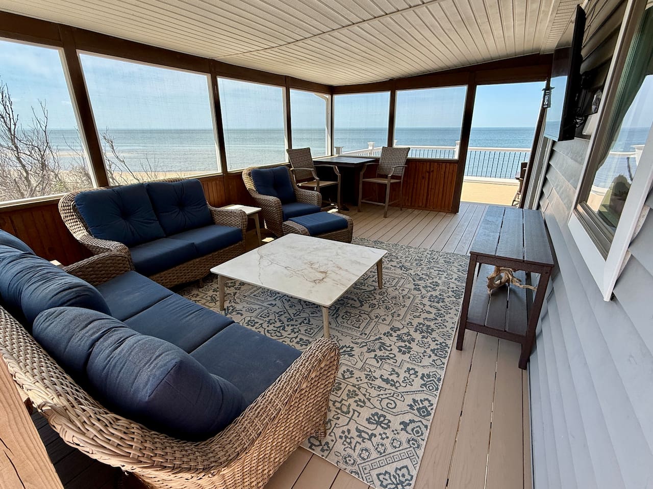 Unwind in this elegant screened-in porch, the ultimate luxury relaxation space. Featuring comfortable wicker seating and panoramic ocean views, it is the perfect spot to enjoy the coastal breeze in total comfort.