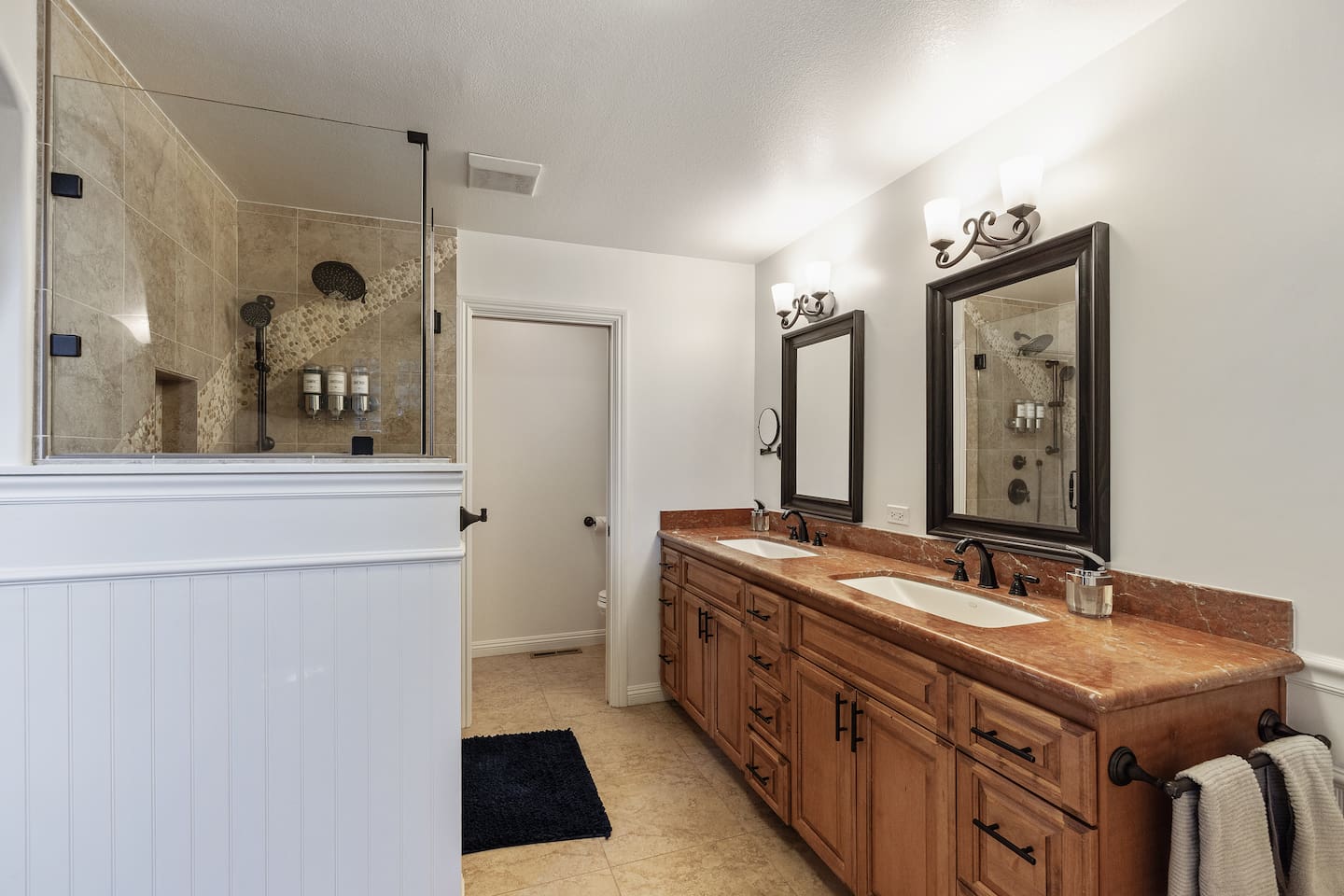 Primary Bedroom ensuite Bathroom: two-sink vanity, standing shower, private toilet room.