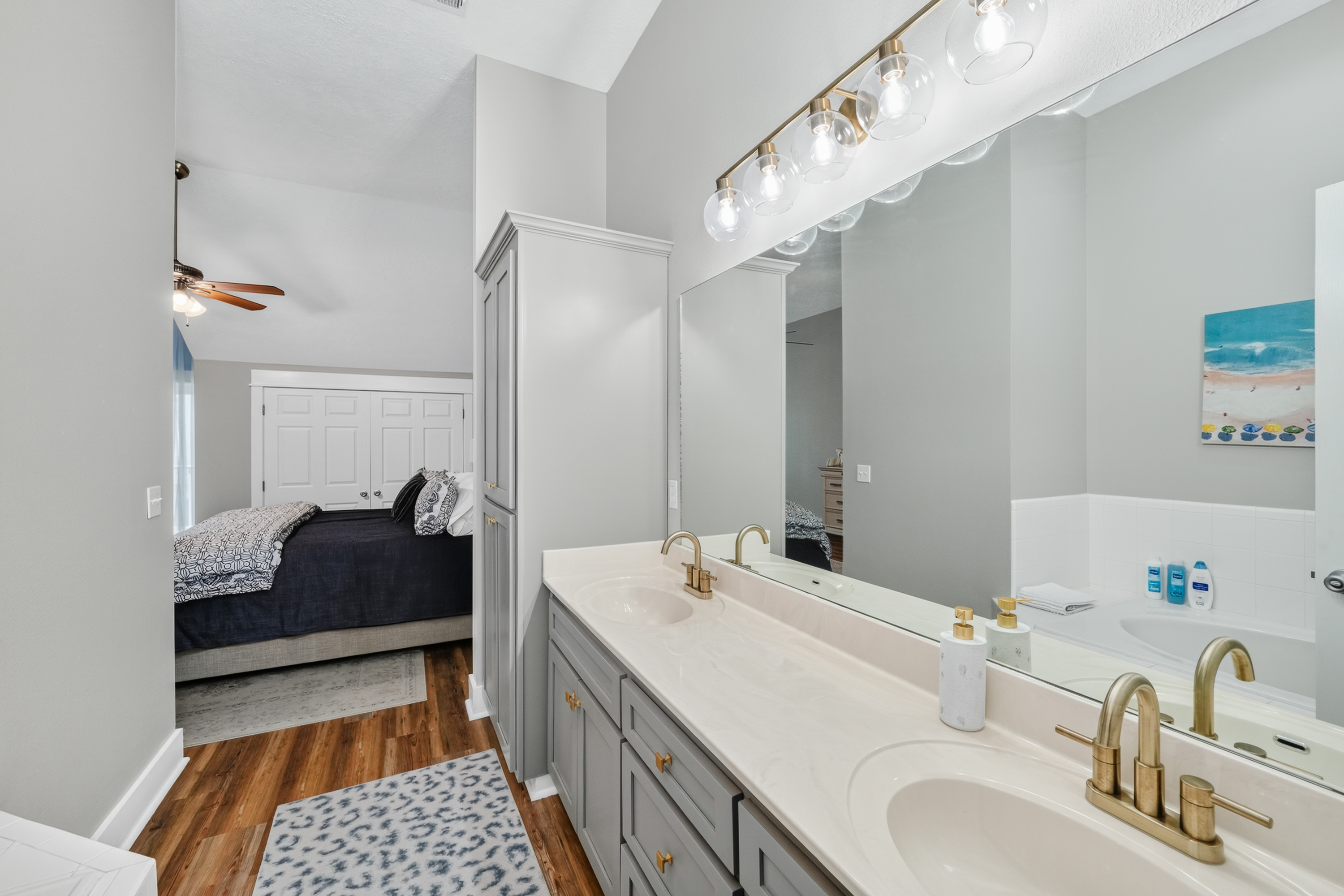 Enjoy the convenience of a private en-suite bathroom with dual vanities, a full-size bathtub, and plenty of space to refresh and unwind after a day of adventure