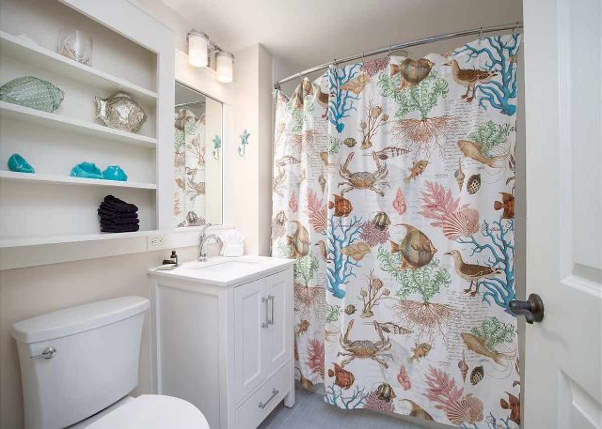 Full bathroom with tub and shower, single vanity and built-in shelving
