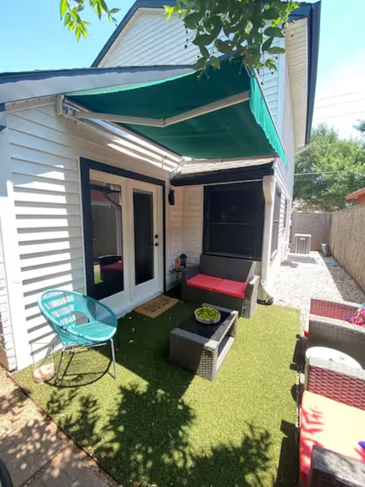 Backyard with patio seating and kid-friendly play space.