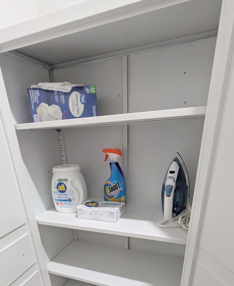 Cabinet next to laundry has all the necessary supplies.