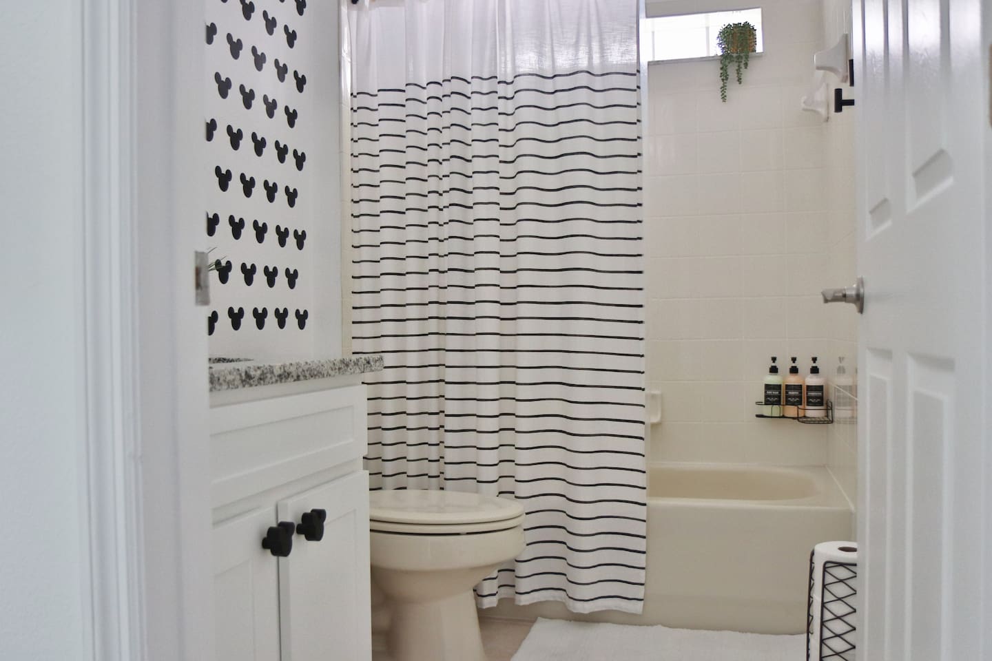 Fun Mickey Mouse themed full bathroom stocked with body wash, shampoo and conditioner 